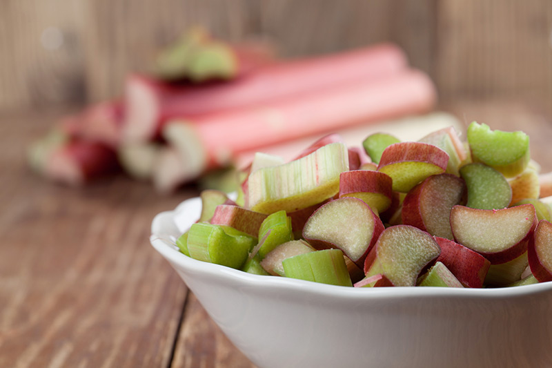 Rhubarb stalks in bowl and background