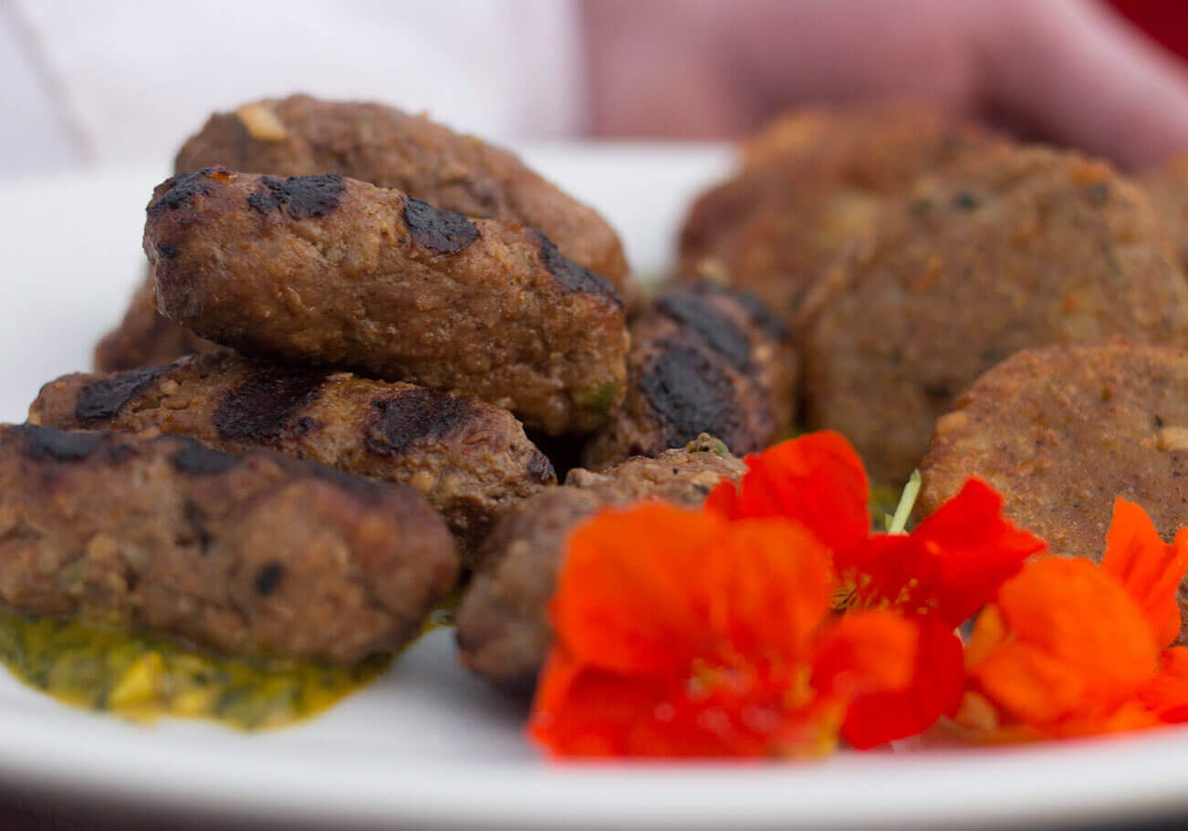 Ground lamb kebabs with mint chutney. Spiced potatoes tikki. // Photo credit: Richard Schroeter