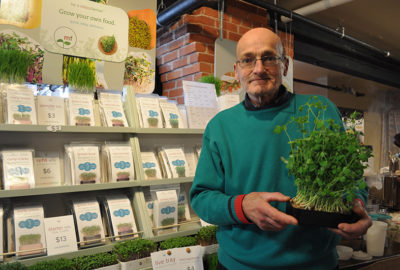 Allan Bridle hols sprouting kit in front of his booth at Summerside Farmers Market