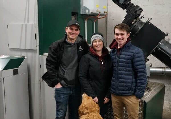  l-r: Marc, Krista, and Ben Schurman (and Zoey the dog) in front of one of the new boilers
