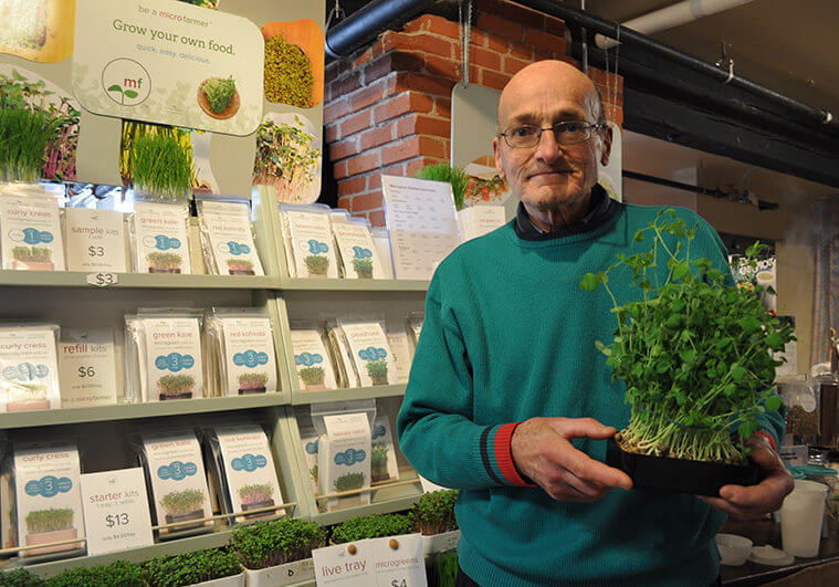 Allan Bridle hols sprouting kit in front of his booth at Summerside Farmers Market