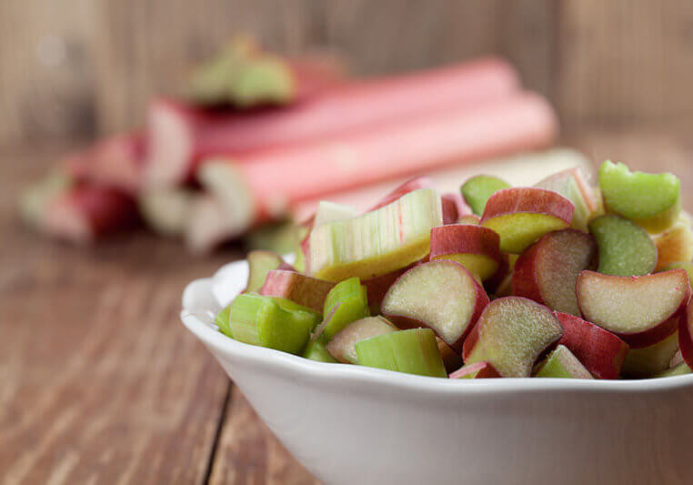Rhubarb stalks in bowl and background